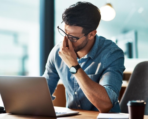 Business person stressed at office desk